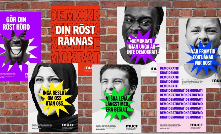 Bild på affischer med ansikten mot en tegelvägg